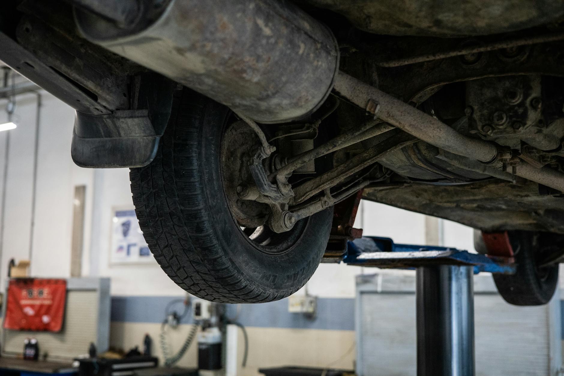 Mechanik ogląda podwozie samochodu Renault na podnośniku w serwisie