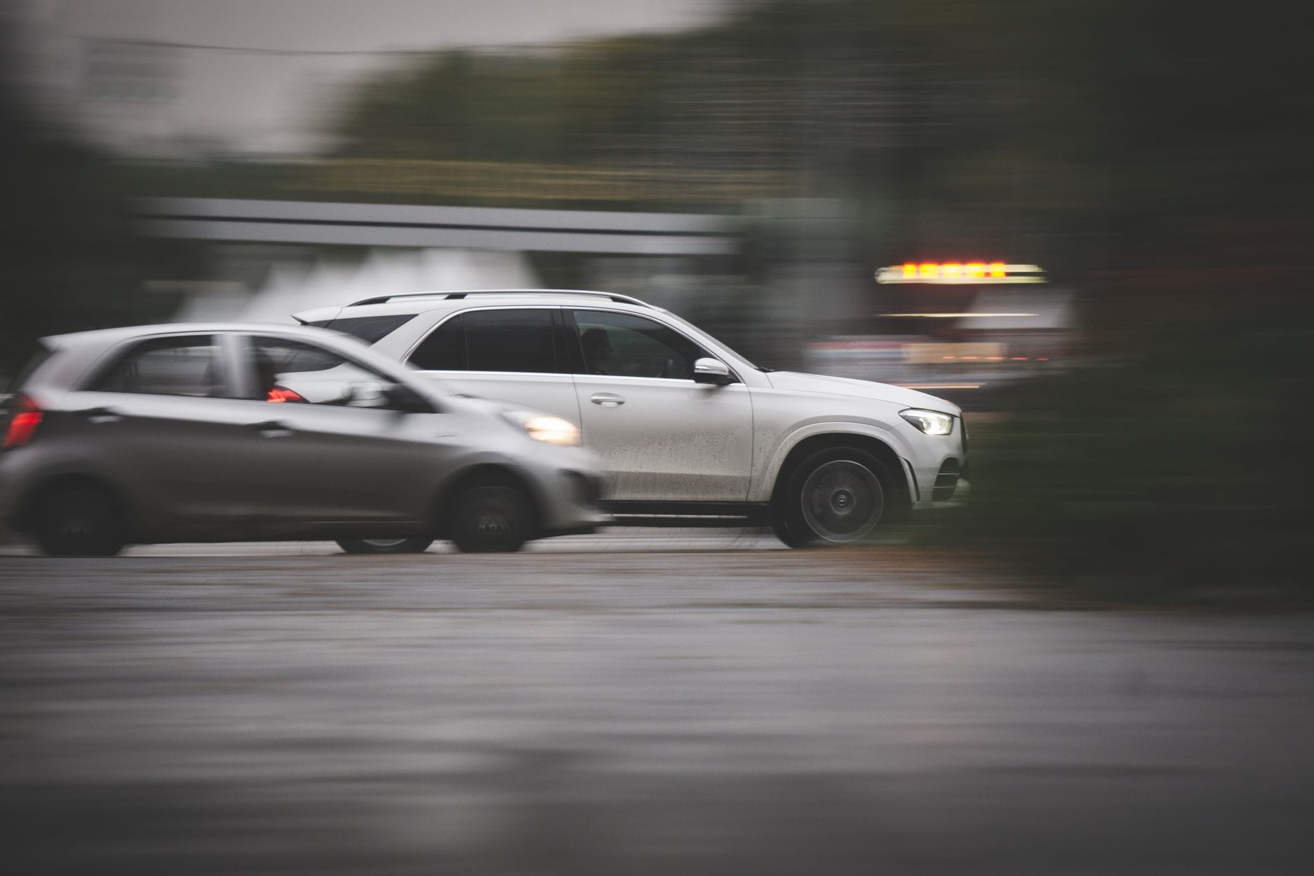 Dwa crossovery Renault jadą szybko po miejskiej ulicy